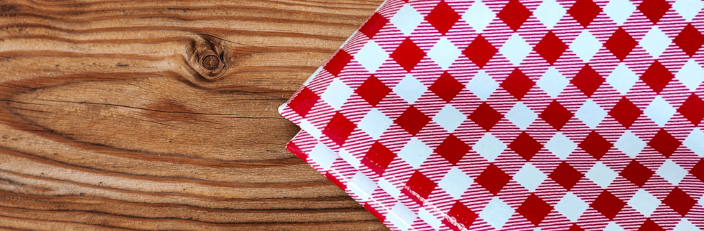 red and white gingham checks on a wooden board 